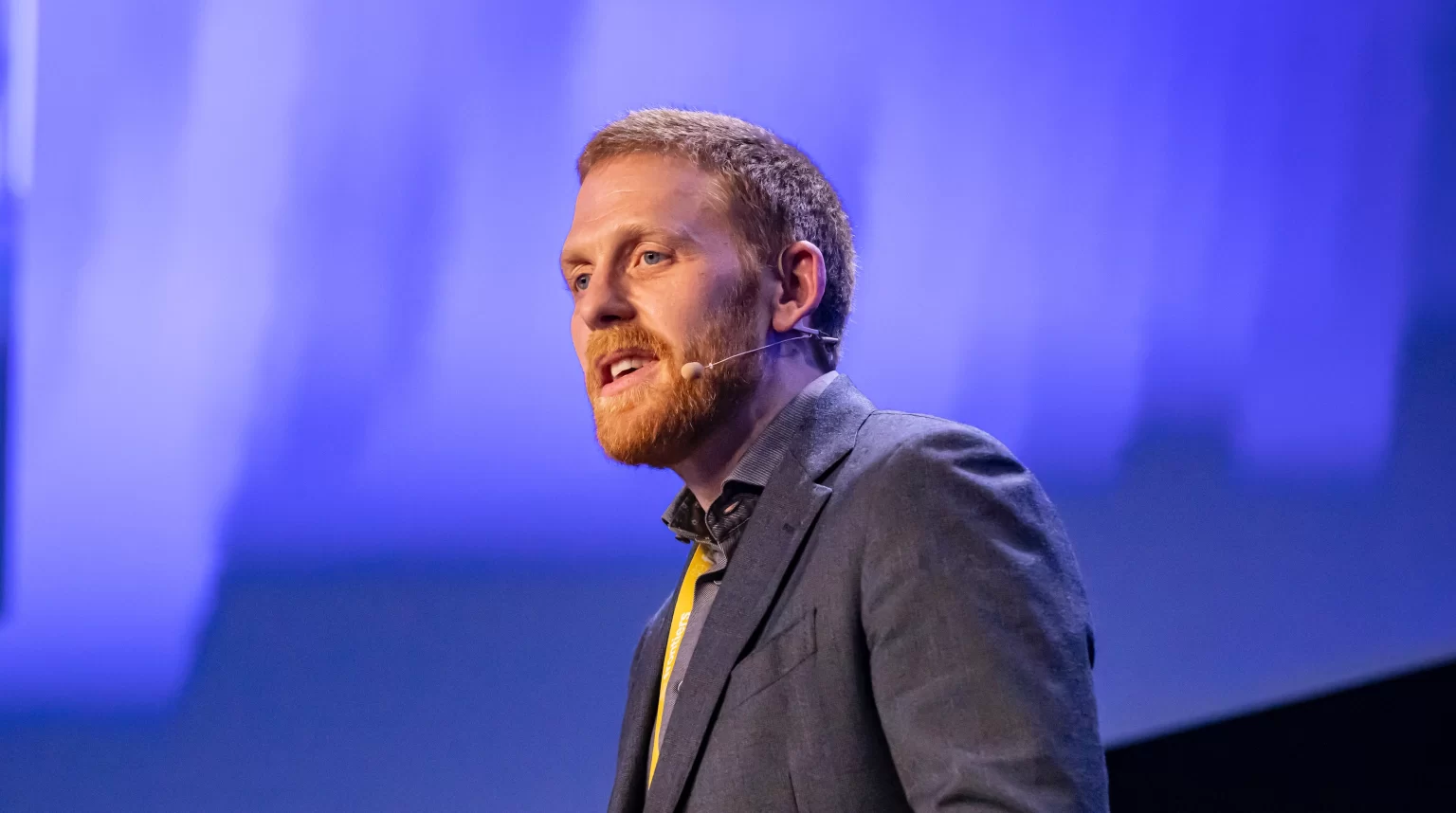 Paul Behrens speaking on stage