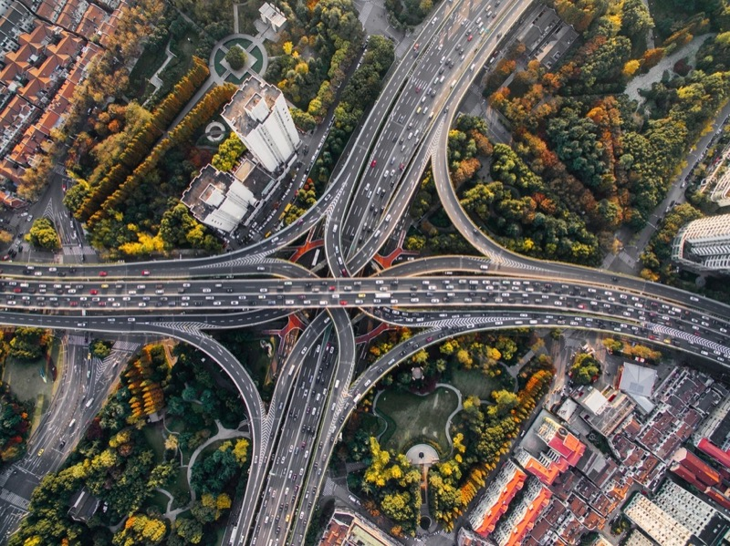 Urban efficiency and rural redundancy: global transportation infrastructure resource demand from 2010–2070